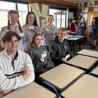 Holding their kindness initiative cards are Dunstan High School students (back, from left)...