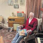 Trevor Stanley relaxes in an armchair in the replica 1960s-70s dining room and lounge he and his...