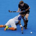Sumit Sumit, of India, dives in to steal the ball from New Zealand's Blair Tarrant at the Paris...