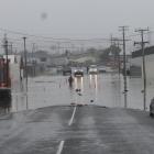 People were wading through water to get to their cars in Balclutha during Thursday’s flooding....