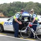 Police officers attend a fatality involving a cyclist who ran off the Portobello Rd cycleway,...