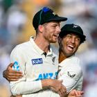 Black Caps second test hero Mitchell Santner (left) is embraced by team-mate Rachin Ravindra at...