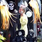 Terri Doolan, of St Kilda, poses with Stanley, the Grim Reaper, while preparing her front lawn...