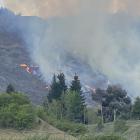 Helicopters are being used in an attempt to control a fire in Arrowtown this afternoon. PHOTO:...