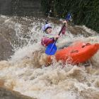A kayaker negotiates the floodwaters as he heads down the Water of Leith outside the University...