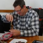 Steve Carr fixes a Thunderbirds Fab 1 model car at the Waitaki Resource Recovery Trust’s Repair...