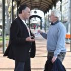 Dunedin Mayor Jules Radich hands a Save Dunedin Hospital postcard to a former Dunedin resident of...