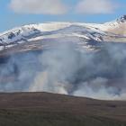 Smoke rising from the Tekapo Military Training Area while firefighters work to contain the 200...
