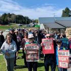 Protesters take part in a 300-strong march through Wānaka on Saturday in opposition to the...