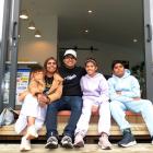 Sitting on the front doorstep of their new home on Saturday are the happy winners of the Otago...