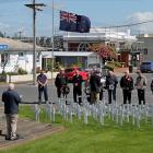About 20 people assembled before 65 symbolic crosses to remember Armistice Day, in Balclutha last...