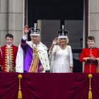 King Charles and Queen Camilla wave to the crowds from the Buckingham Palace balcony at last year...