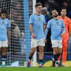 Manchester City players react after conceding their third and equalising goal this morning. Photo...