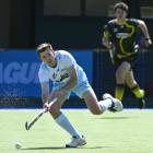 Alpiners player Mick Findlay controls the ball with Falcons player Matt Wilson at rear. PHOTO:...