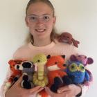 Rinah Bird, 13, holds her crocheted critters which will be for sale at the children’s market this...