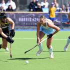 Falcons defender Stephanie Dickins charges down a penalty corner while Alpiners player Sophie...