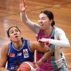 Hoiho guard Ahlise Hurst tries to get a look at the hoop in front of Whai defender Kaylee Smiler...