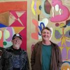 Artist Mark Braunias, right, in front of one of his paintings with art collector Chris Parkin....