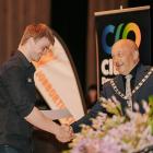 Calo Limited software developer Malachi Batt (left) accepts an award from Clutha Mayor Bryan...