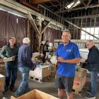 Sorting books for Alexandra’s New Year Rotary book sale in their new location are (from left)...