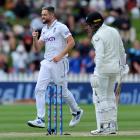 Black Caps opener Devon Conway (right) looks at his shattered stumps as  England quick Chris...
