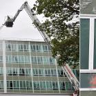 Firefighters use an aerial appliance to spray Hayward College’s windows with water to test their...