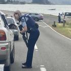 Armed police at a checkpoint near Aramoana this morning. Photo: Stephen Jaquiery 