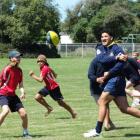 Highlanders new recruit TK Howden passes the ball during a game of touch with Oamaru intermediate...