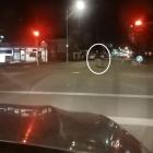A woman runs for her life as the driver runs a red light and bears down on her.