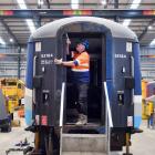 Kerry Hackett works on one of the Pounamu Tourism Group’s railway carriages at the Hillside...