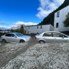 Properties and cars in Reavers Lane, Queenstown, affected by slips. Photo: RNZ