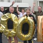Holding balloons to celebrate the St John Health Shuttle reaching 100,000km are St John...