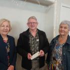 South Canterbury Travel Club members Ann White (left) and Sue Thin hand over the now-defunct club...