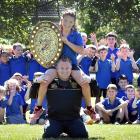 Green Island Rugby Football Club players of Abbotsford School put their claws up as Ollie Moore,...