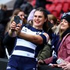 American rugby star Ilona Maher poses for a photograph with fans after making her debut for...