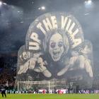 Aston Villa football fans display a banner of musician Ozzy Osbourne before their Champions...