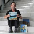Skier Grant McKenzie shows some of the pieces in an art fundraiser which will help him to get to...