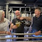 Gadoochi Brewery owners Nicola McGilvray and Chris Ellenden watch as brewer Damon Milne pours a...