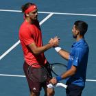 Novak Djokovic (right) of Serbia shakes hands with Alexander Zverev of Germany shake hands...