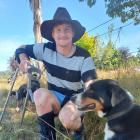 Injured cowboy Mitchell Gunn was back at the Lawrence rodeo arena on Friday to sell dogs Leo ...