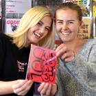 Critic Te Ārohi features editor Iris Hehir (left) and editor Nina Brown hold a mock-up of the...
