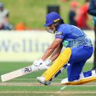 Otago wicketkeeper Max Chu plays a reverse sweep during a match against Wellington at the Basin...