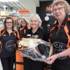 Tamara Robinson, left, Carmen Boylen and Oamaru Mitre 10 manager Nicky Kofoed present a hamper to...