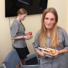 Free lunch . . . Maruawai College year 9 student Leah Comptom (13, right) tries the beef...