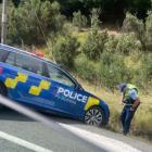 A police officer checks his patrol vehicle after going off road while trying to perform a U-turn....