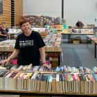 Regent Theatre 24 Hour Book Sale volunteer Jill Bowie looks over the almost-completed literary...