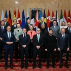 Ukraine's President Volodymyr Zelensky (second right) stands with numerous world leaders...