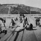 Workers lay Malthoid roofing membrane at the New Zealand and South Seas Exhibition construction...