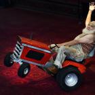 Alain Carabinier, of Quebec, does a wheelie on a miniature tractor in the foyer of the Regent...