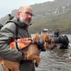 Rodent spotter Piki and her dog handler, Fin Buchanan, arriving at mouse-infested Auckland Island...
